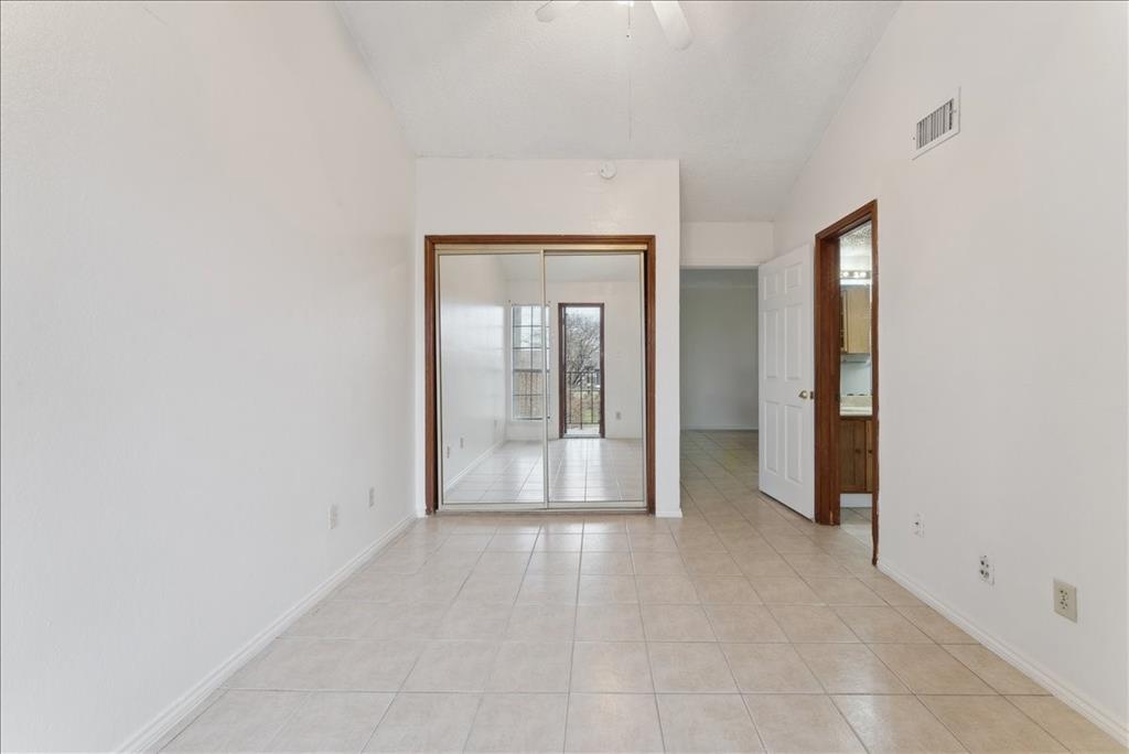 6108 Abrams Road, Unit 330 Dallas, TX 75231 - Photo 17 of 18 an empty room with mirror and a bathroom