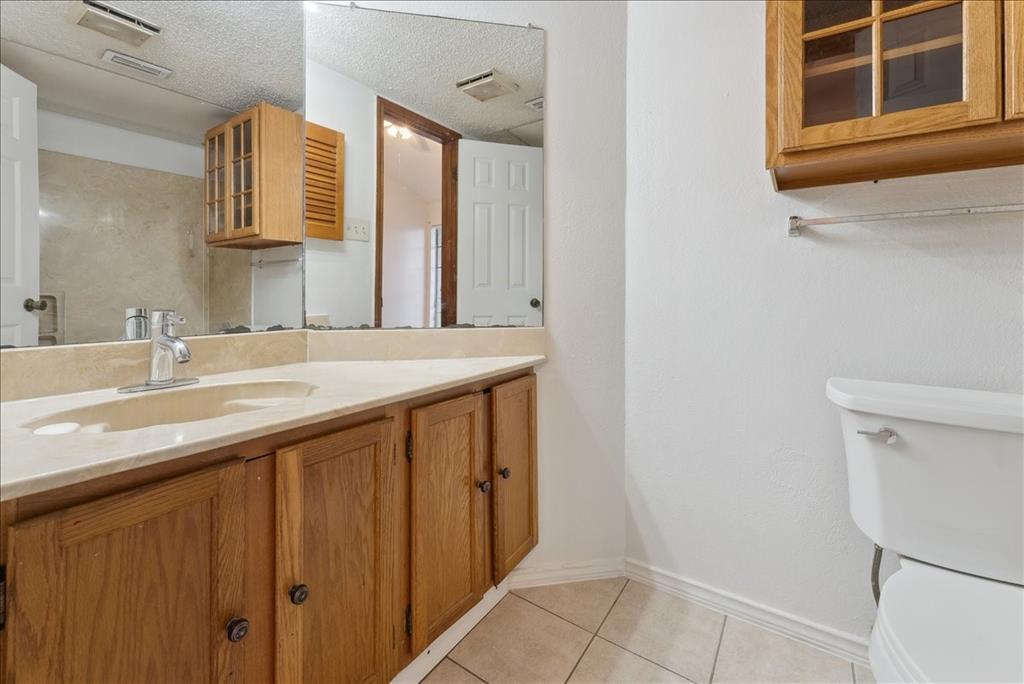 6108 Abrams Road, Unit 330 Dallas, TX 75231 - Photo 18 of 18 a bathroom with a sink and a mirror