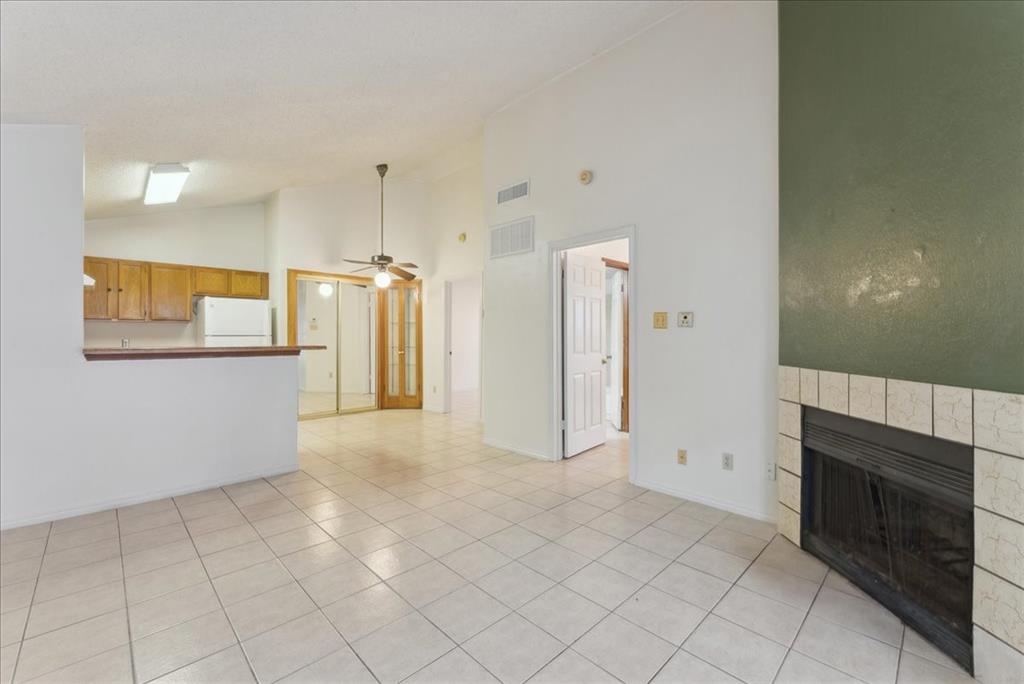 6108 Abrams Road, Unit 330 Dallas, TX 75231 - Photo 4 of 18 a view of a kitchen with an empty space and a fireplace
