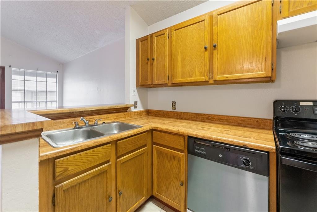 6108 Abrams Road, Unit 330 Dallas, TX 75231 - Photo 5 of 18 a kitchen with a sink and cabinets