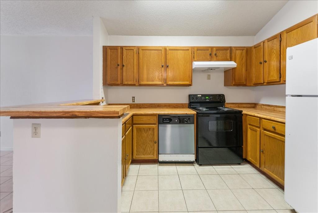 6108 Abrams Road, Unit 330 Dallas, TX 75231 - Photo 7 of 18 a kitchen with a sink a stove top oven and cabinetry