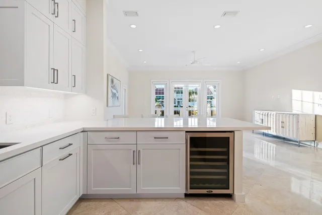 a kitchen with white cabinets and white appliances