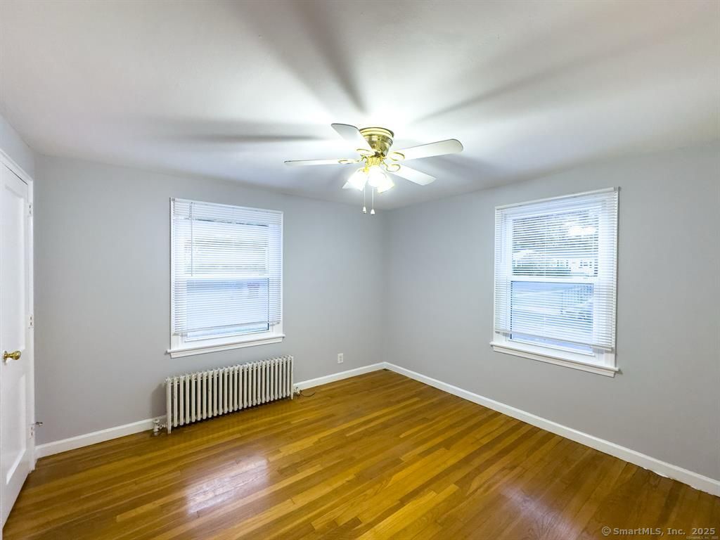 111 Irving Left Side Street Naugatuck, CT 06770 - Photo 2 of 11 a view of an empty room with wooden floor and a window