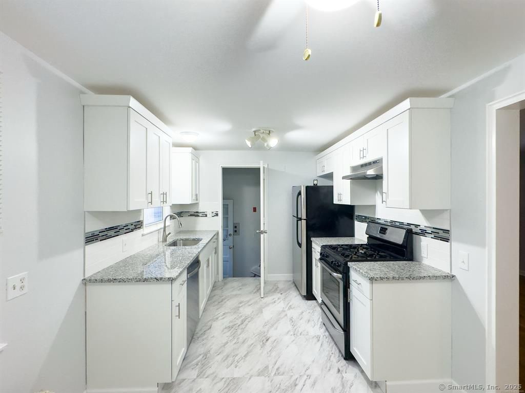 111 Irving Left Side Street Naugatuck, CT 06770 - Photo 3 of 11 a large kitchen with kitchen island a sink stove and refrigerator