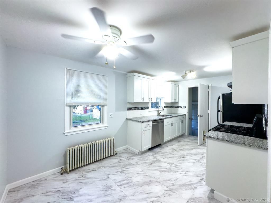 111 Irving Left Side Street Naugatuck, CT 06770 - Photo 6 of 11 a kitchen with a refrigerator and microwave