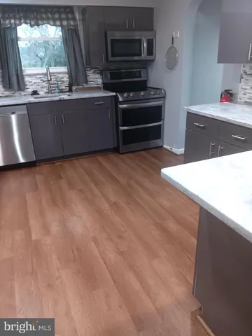 a kitchen with wooden cabinets and a stove top oven