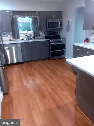 a kitchen with stainless steel appliances a stove and a refrigerator