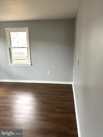a view of an empty room and wooden floor