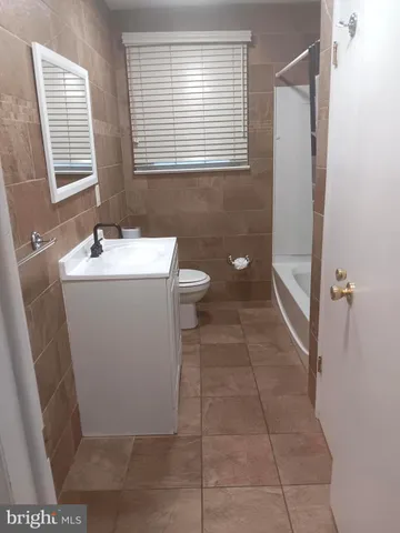 a bathroom with a sink a toilet and a shower