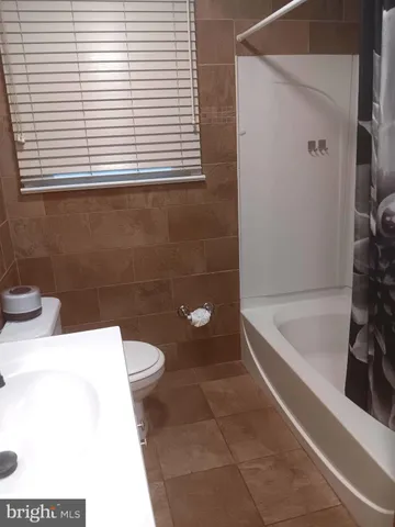 a bathroom with a toilet a sink and bathtub