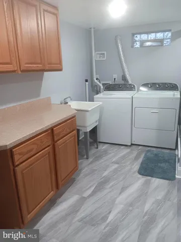 a kitchen with a sink window and cabinets
