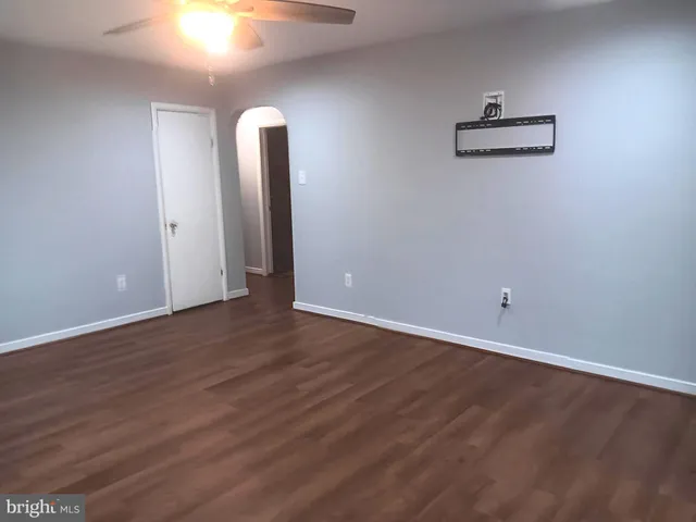 a view of a room with wooden floor