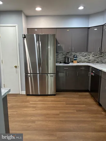 a kitchen with stainless steel appliances granite countertop a refrigerator and a sink