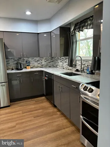 a kitchen with stainless steel appliances granite countertop a sink and cabinets