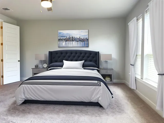 a bedroom with a bed and a large window