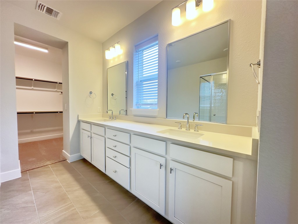 111 Pinyon Pne Drive Bastrop, TX 78602 - Photo 9 of 16 a spacious bathroom with a double vanity sink mirror and