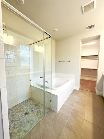 a bathroom with a bathtub and a shower