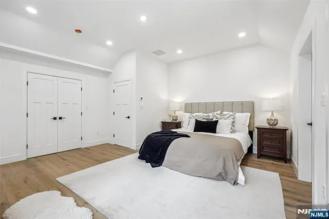 a spacious bedroom with a bed and a couch