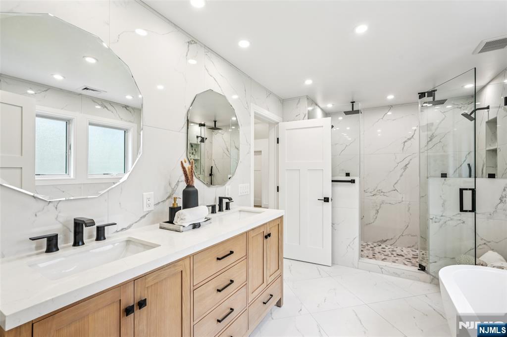 492 Oaktree Road Oradell, NJ 07649 - Photo 22 of 43 a spacious bathroom with a double vanity sink mirror and shower