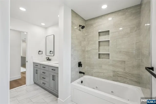 a bathroom with a bathtub shower sink and toilet