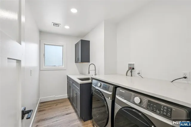 a kitchen with stainless steel appliances granite countertop a sink and cabinets