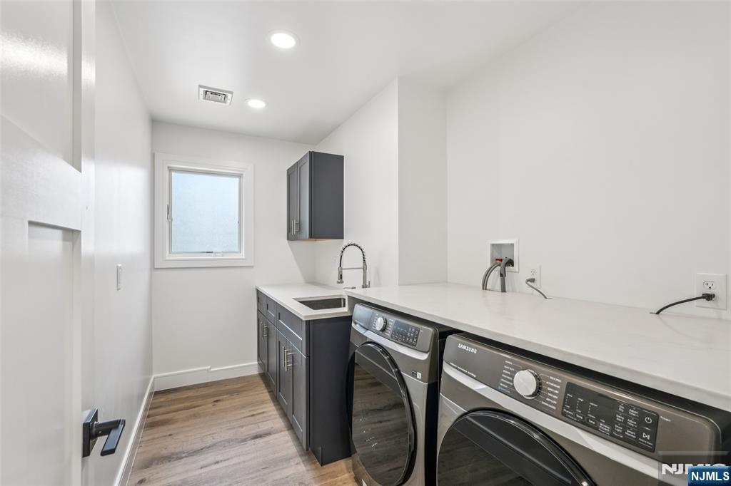 492 Oaktree Road Oradell, NJ 07649 - Photo 31 of 43 a kitchen with stainless steel appliances granite countertop a sink and cabinets