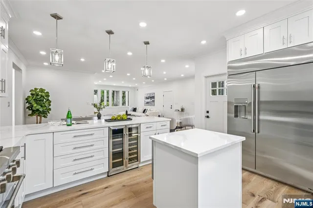 a kitchen with a white wooden cabinets and white appliances