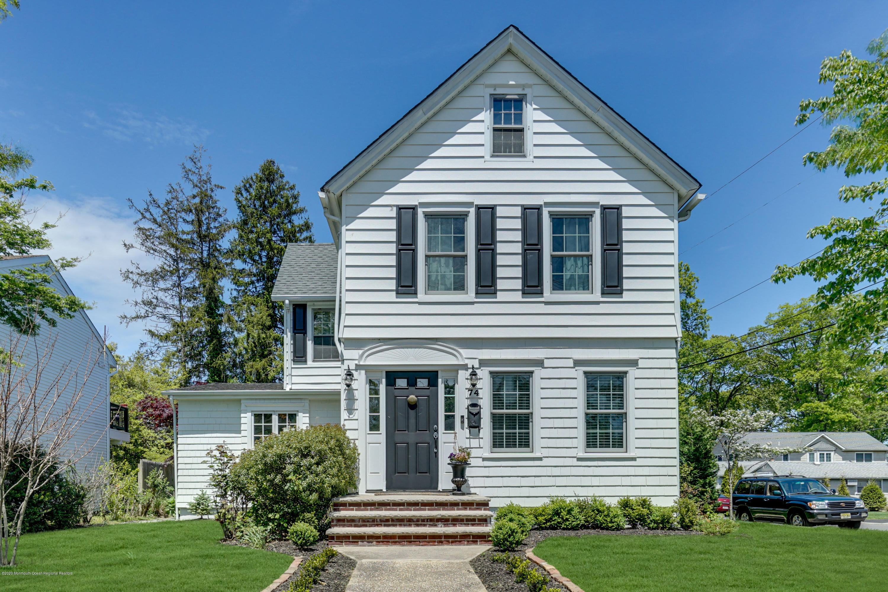 74 Black Point Road Rumson, NJ 07760 - Photo 1 of 36 a front view of a house with a yard