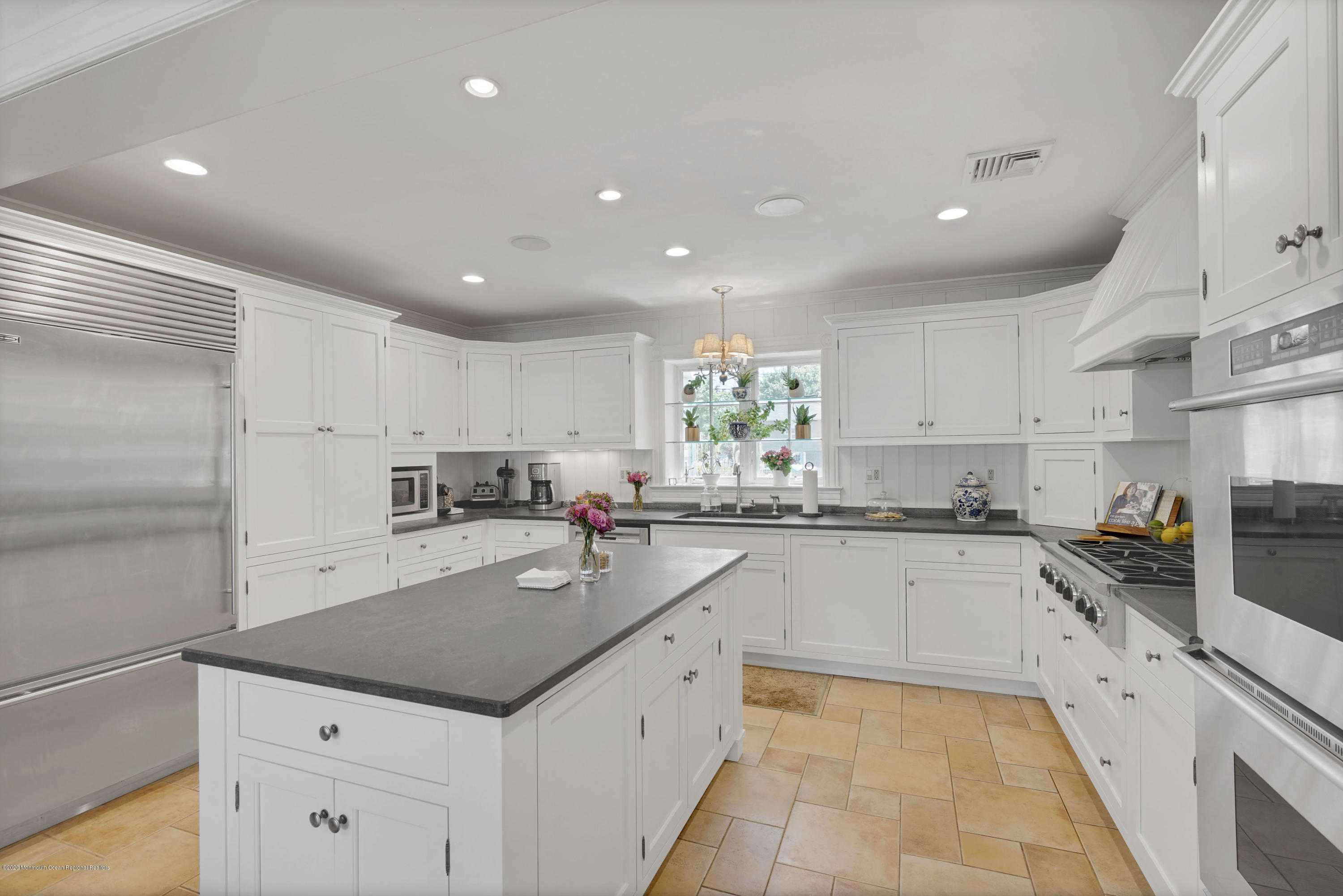 74 Black Point Road Rumson, NJ 07760 - Photo 11 of 36 a kitchen with a sink window and cabinets