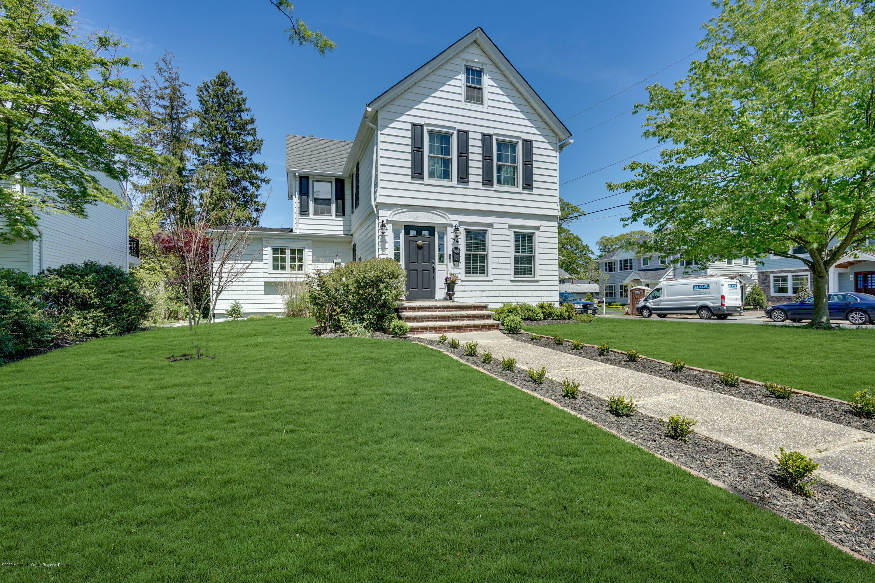 74 Black Point Road Rumson, NJ 07760 - Photo 2 of 36 a front view of a house with a yard