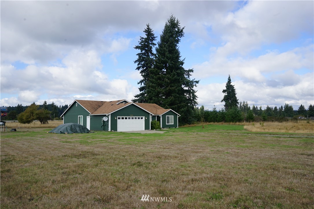 16823 Leitner Road Southwest Rochester, WA 98579 - Photo 2 of 31 a front view of a house with a yard and trees
