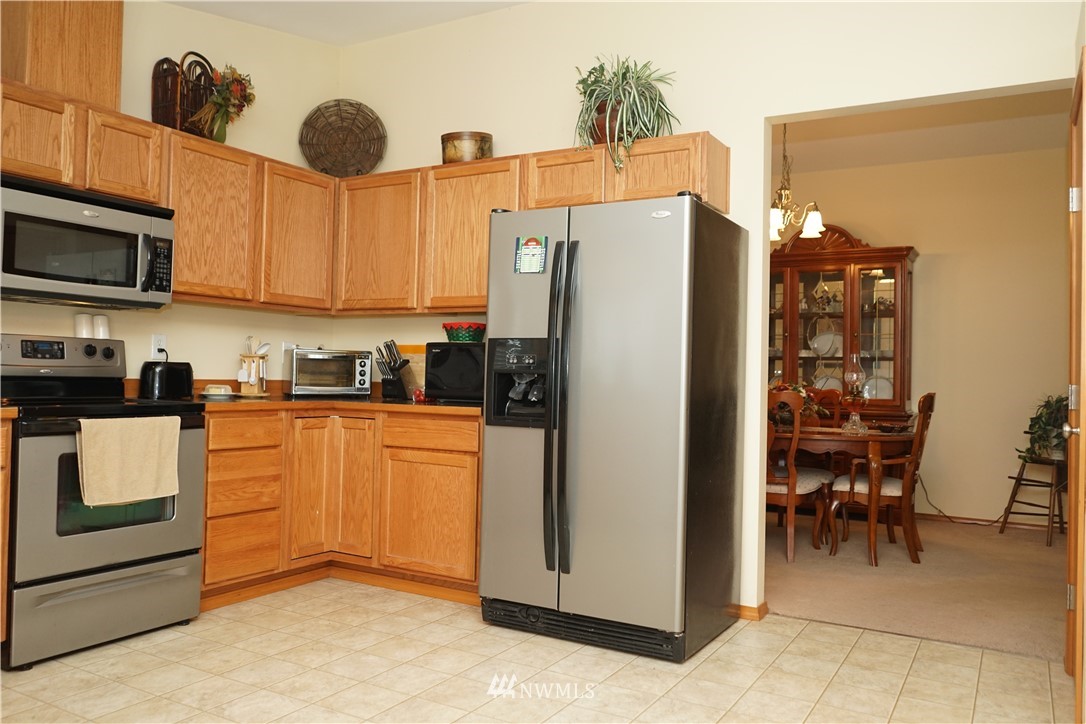16823 Leitner Road Southwest Rochester, WA 98579 - Photo 14 of 31 a kitchen with stainless steel appliances granite countertop a refrigerator and a stove top oven