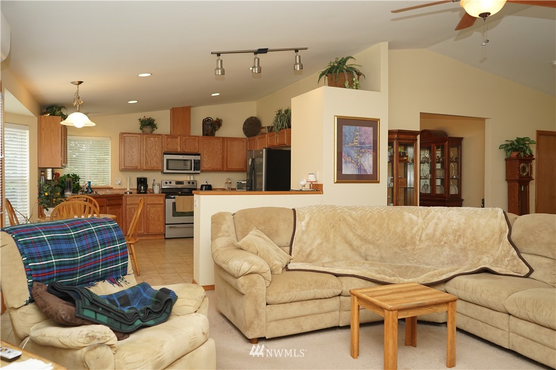 16823 Leitner Road Southwest Rochester, WA 98579 - Photo 16 of 31 a living room with furniture kitchen view and a chandelier