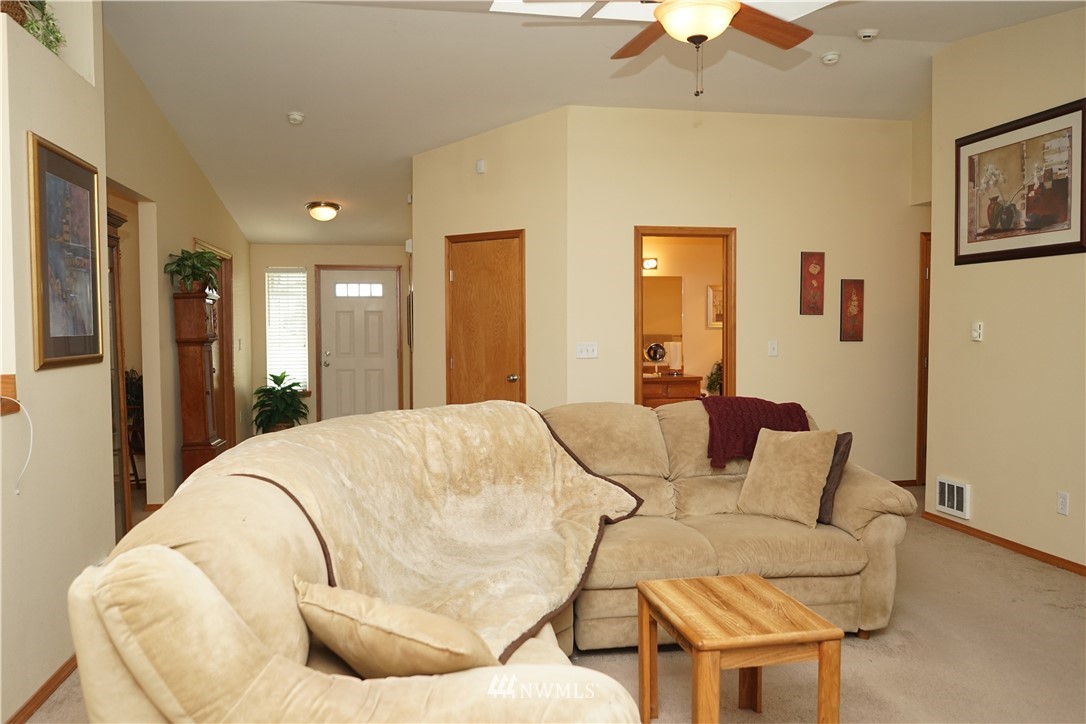 16823 Leitner Road Southwest Rochester, WA 98579 - Photo 17 of 31 a living room with a bed and a chandelier