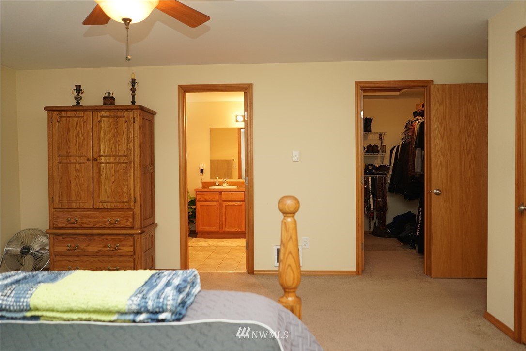 16823 Leitner Road Southwest Rochester, WA 98579 - Photo 24 of 31 a bedroom with a bed and a chandelier