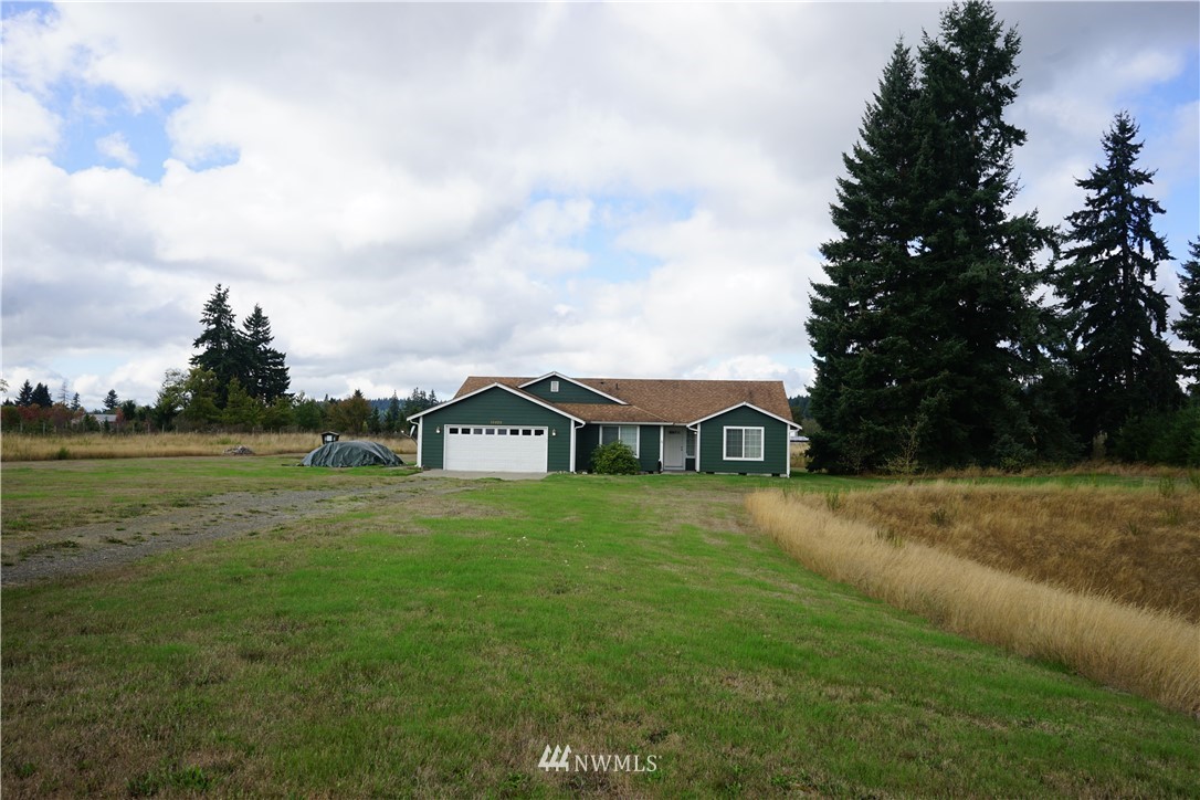 16823 Leitner Road Southwest Rochester, WA 98579 - Photo 7 of 31 a view of a yard with a house in the background
