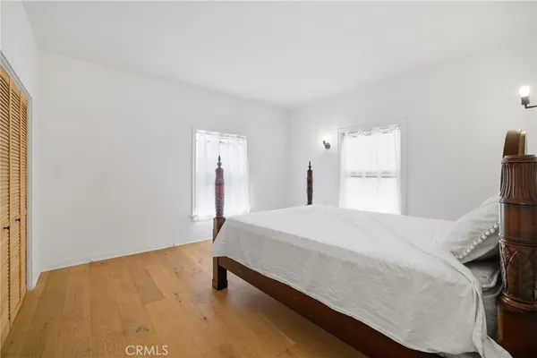 a room with a bed and a dresser
