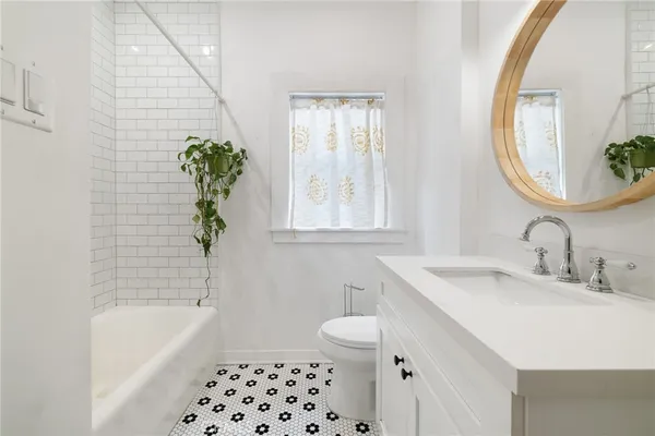a bathroom with a sink a toilet and bathtub