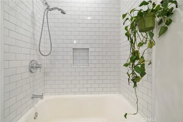 a bath tub sitting in a bathroom next to a shower