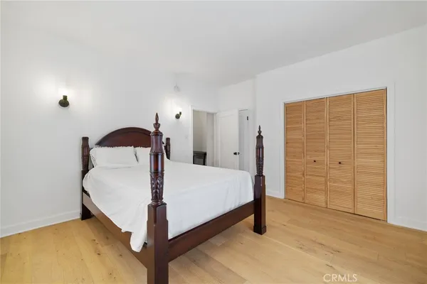 a bedroom with a bed and a closet