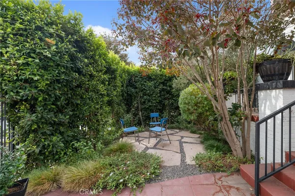 a view of a backyard with sitting area and garden