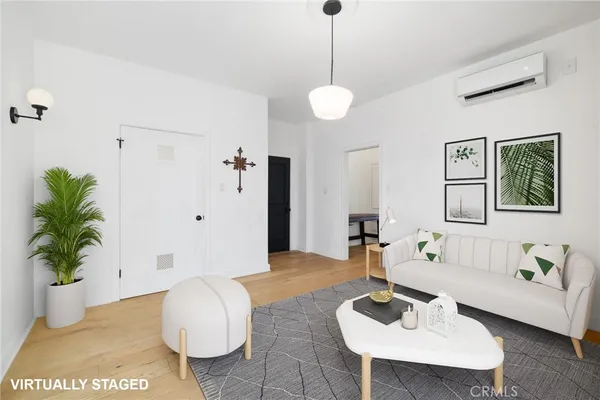 a living room with furniture and a potted plant