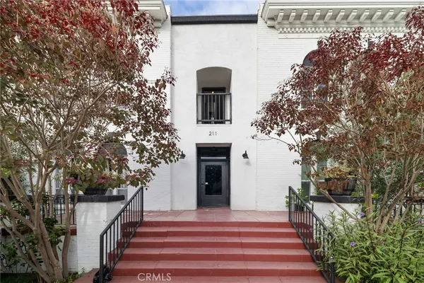 a front view of a house with trees