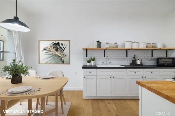 a kitchen with stainless steel appliances granite countertop a white cabinets and a stove