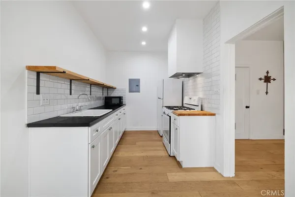 a kitchen with stainless steel appliances granite countertop a sink and cabinets