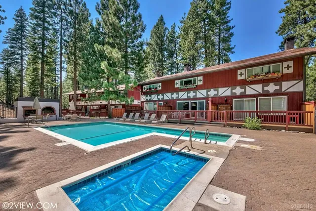 a view of a house with pool and sitting area