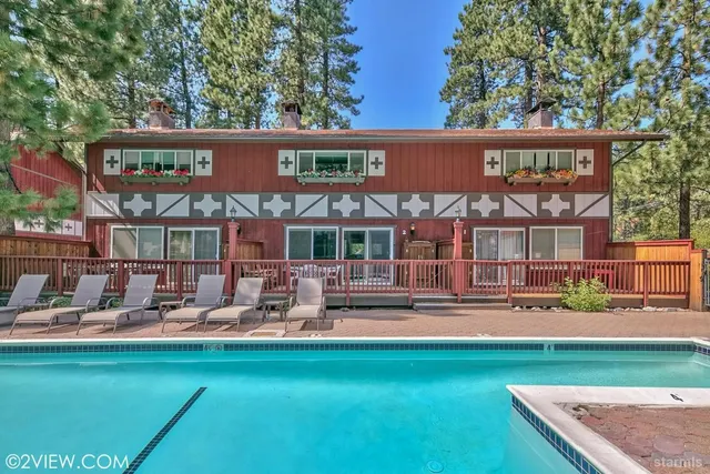 a front view of a house with swimming pool having outdoor seating
