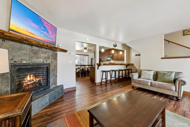 a living room with fireplace furniture and a wooden floor