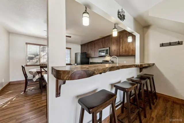 a kitchen with a dining table chairs and microwave