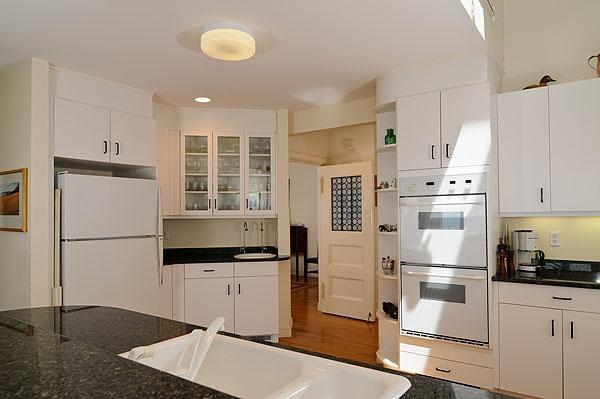 48 Bourne Point Road Wareham, MA 02571 - Photo 11 of 23 a kitchen with granite countertop a refrigerator a sink and white cabinets